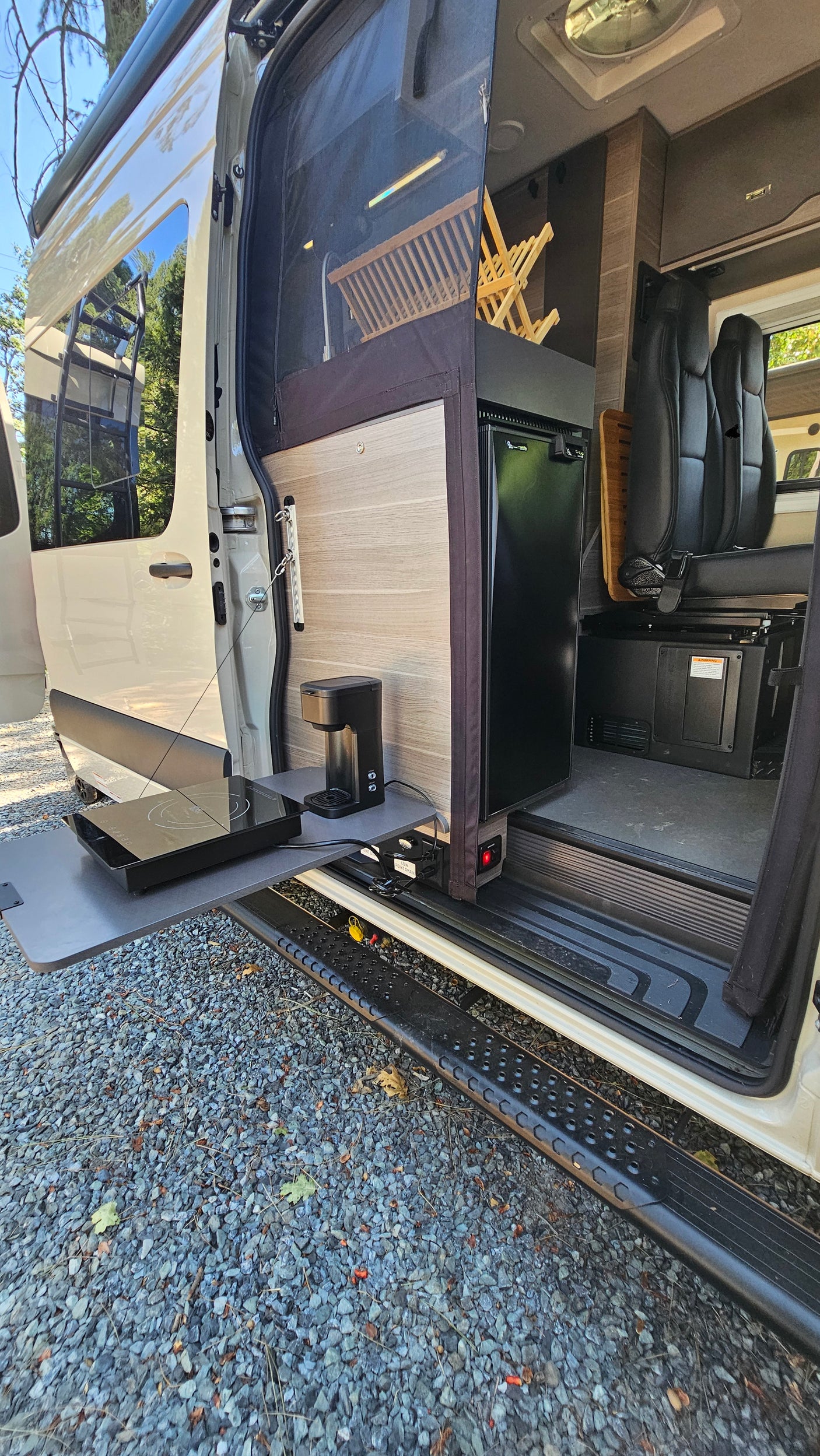RV rental with convenient pull-out outdoor kitchen, featuring a coffee maker and induction cooktop, perfect for camping.