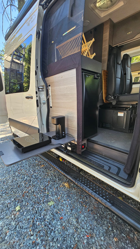 RV rental with convenient pull-out outdoor kitchen, featuring a coffee maker and induction cooktop, perfect for camping.