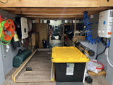 Explore the organized under-bed storage in this RV rental, featuring a Growatt inverter, Camplux water heater, and storage bin.