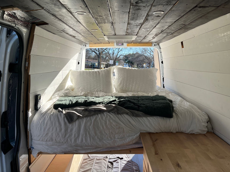  and warm lighting.|White Mercedes-Benz Sprinter van with roof rack — photo 2