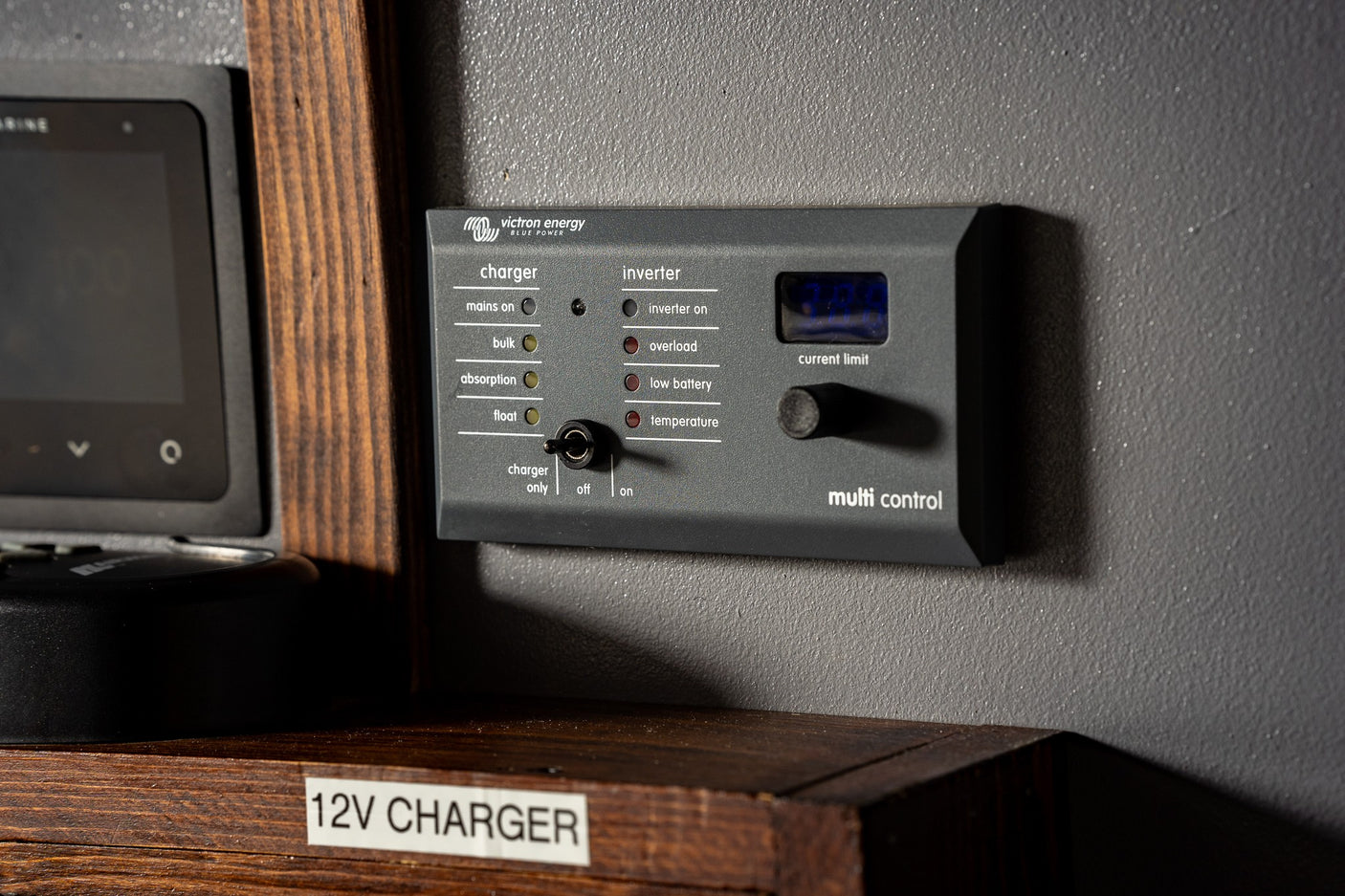 An RV rental's Victron Energy Multi Control panel, managing charger modes and inverter status for onboard power.