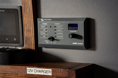 An RV rental's Victron Energy Multi Control panel, managing charger modes and inverter status for onboard power.