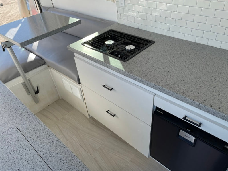  and scenic lake & mountain view.|Modern RV rental interior: compact kitchen with gray counters — photo 7