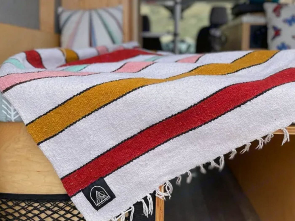  and comfy bench seating.|An RV rental cabinet displays colorful dishes — photo 6