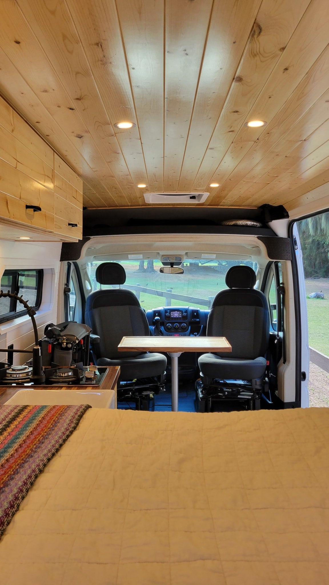  and portable fridge for your mobile journey.|Spacious RV rental interior with wood ceiling — photo 14