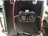 NOCO Genius battery charger on an RV battery box, crucial for RV rental power maintenance.