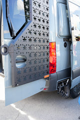 Rear of a customized grey van, featuring a gear mounting panel and an outdoor shower, ideal for an rv rental adventure. TYACKE MOTORS.