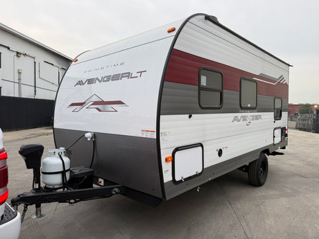 White and maroon Primetime Avenger LT travel trailer, ready for your next rv rental adventure. This compact recreational vehicle is ideal for camping.