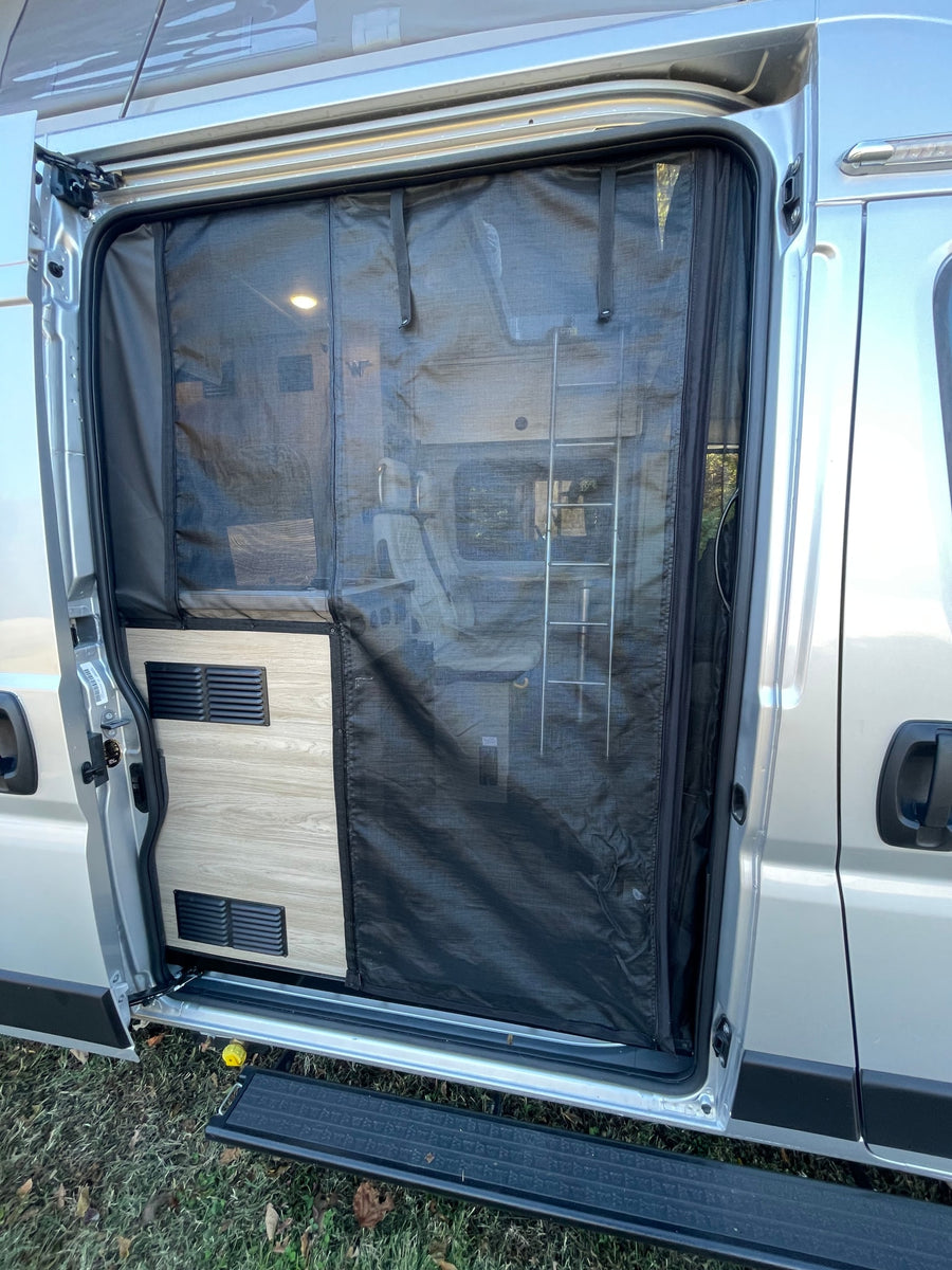 RV rental camper van side door open with an installed black mesh screen, offering ventilation and interior views.