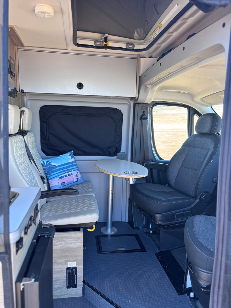 RV rental interior: comfortable seating, an adjustable table, and a compact kitchen. Your next adventure awaits! — photo 12