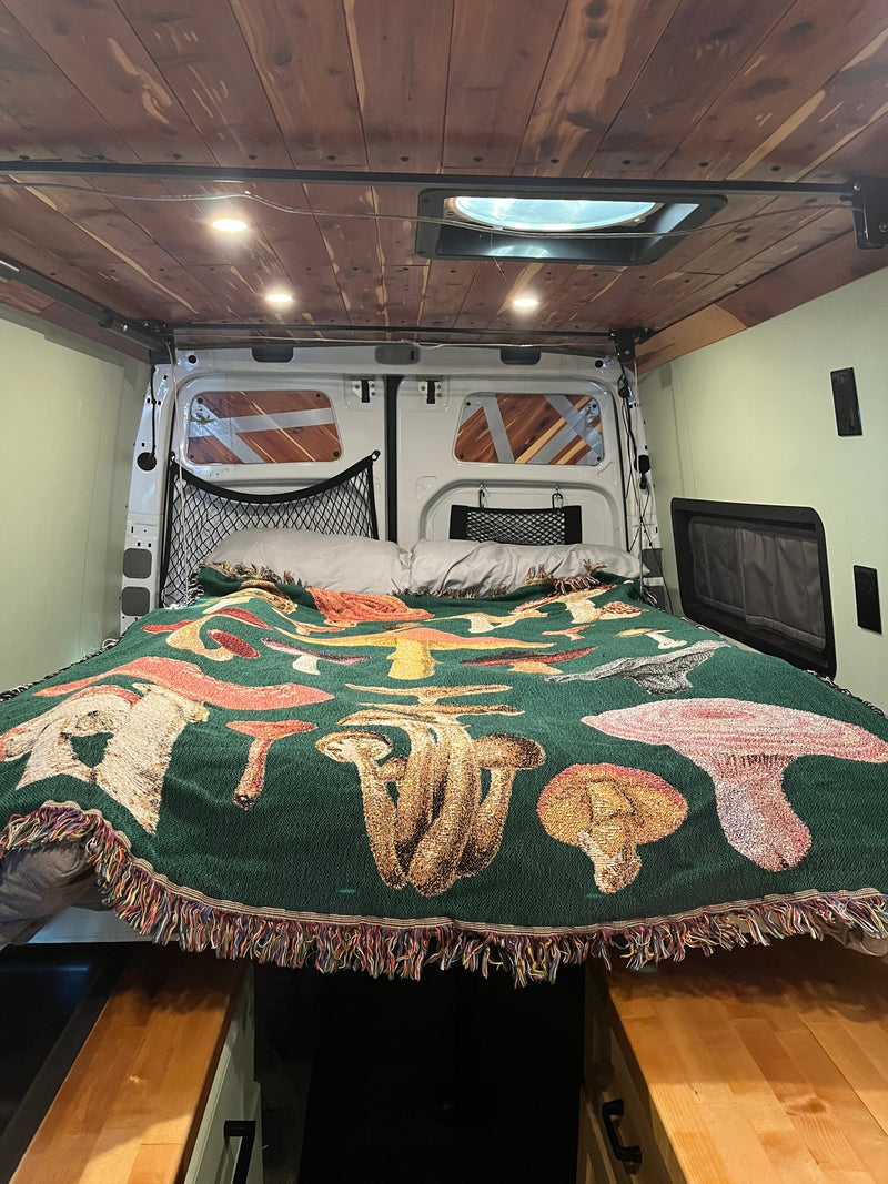  and grid storage. Ideal for van life adventures.|Inviting camper van interior with a dining area and compact kitchen — photo 8