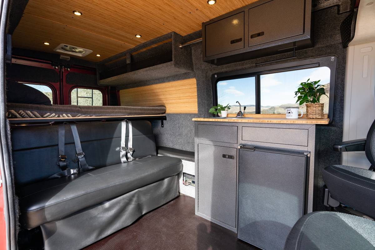  revealing a cozy two-tier bunk bed interior.|RV rental: Camper van interior with cozy bed — photo 7