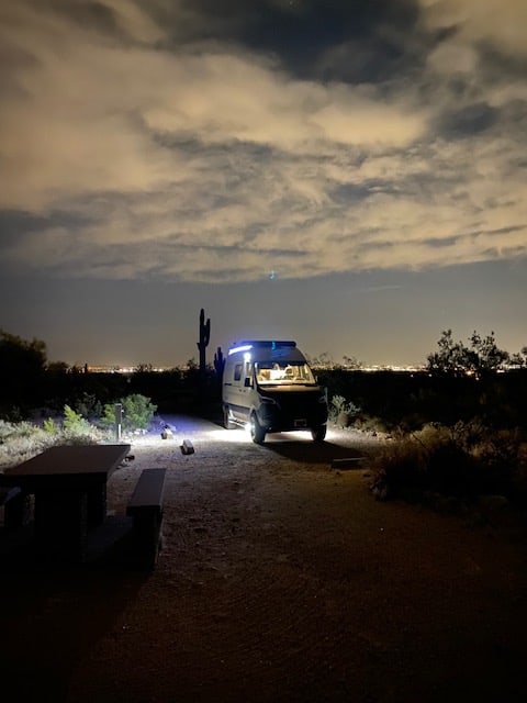  and moonlit sky. Ideal for adventure and boondocking.|Gray Winnebago Revel 4x4 Sprinter camper van for rv rental — photo 6