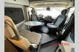 See this RV rental's versatile camper van interior: front cockpit, removable table, and rear bench seating for travel comfort.