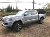 Grey Toyota Tacoma, rooftop tent & toolbox. An agile alternative to an rv rental for rugged exploration.