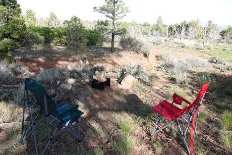 RV rental adventure? Relax at your campsite! Two chairs & fire pit await in nature's quiet embrace.