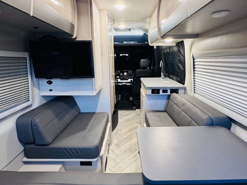  and a side ladder.|White Mercedes Sprinter camper van for RV rental — photo 19