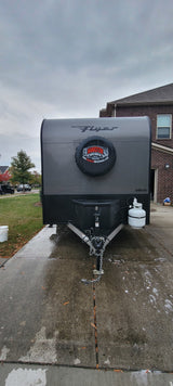 Front of a gray InTech Flyer travel trailer, likely an rv rental from Bankston Motor Homes, on a wet driveway.