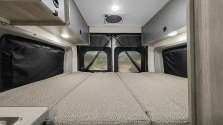  enjoying autumn leaves. Perfect for family travel in a camper van.|RV rental interior: A compact kitchen with sink and fridge