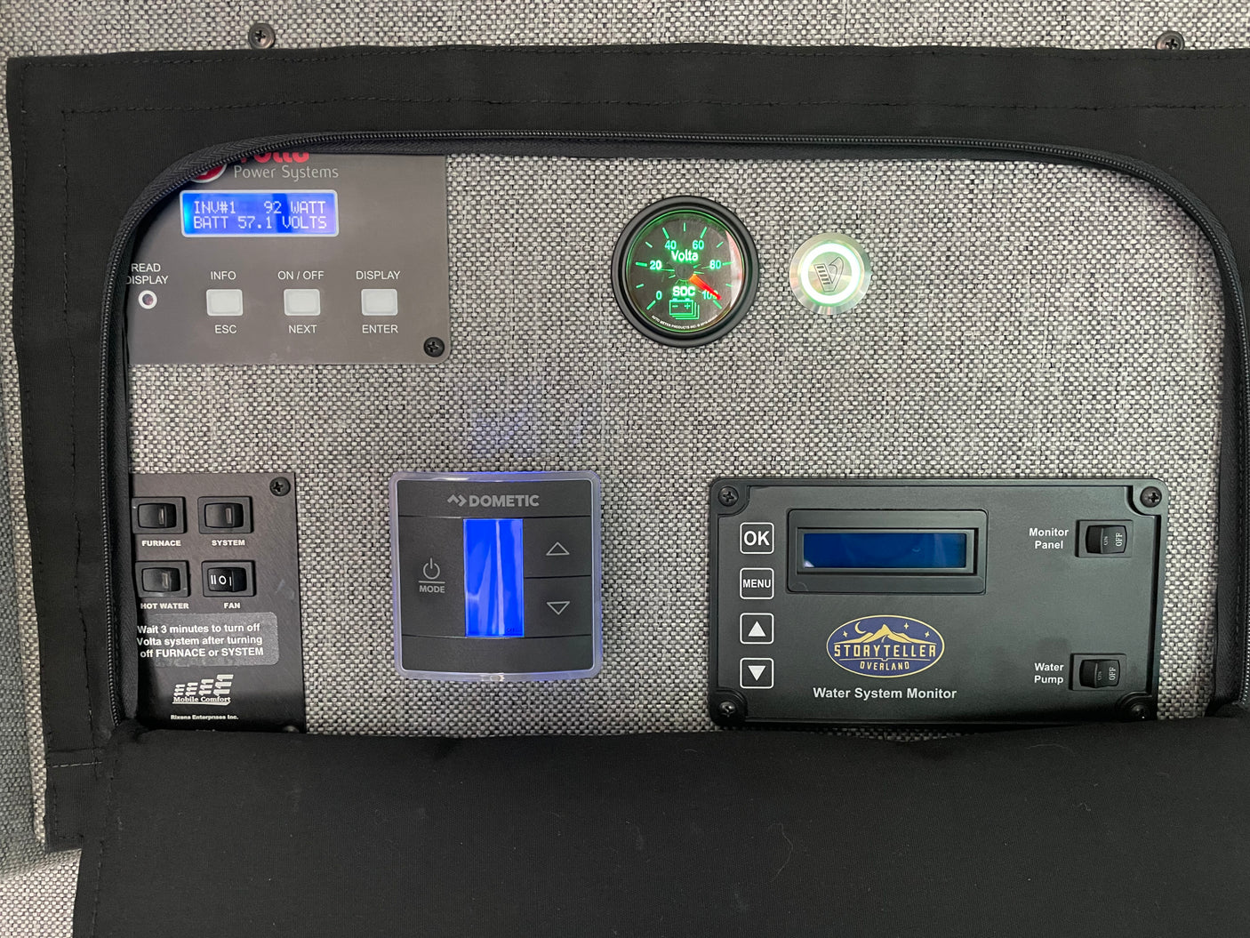 RV rental control panel: displays for power (92W/57.1V battery), Dometic climate control, and Storyteller water system.