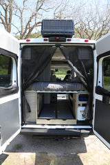 This RV rental's rear offers a comfy bed, pull-out storage, and mesh screen, ideal for camping and road trips.