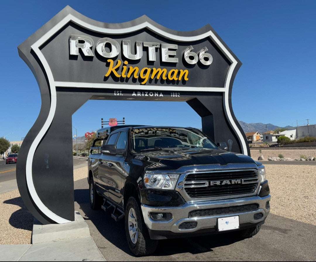 Black Ram pickup under the iconic Route 66 Kingman, Arizona sign. Ideal for your next rv rental road trip!