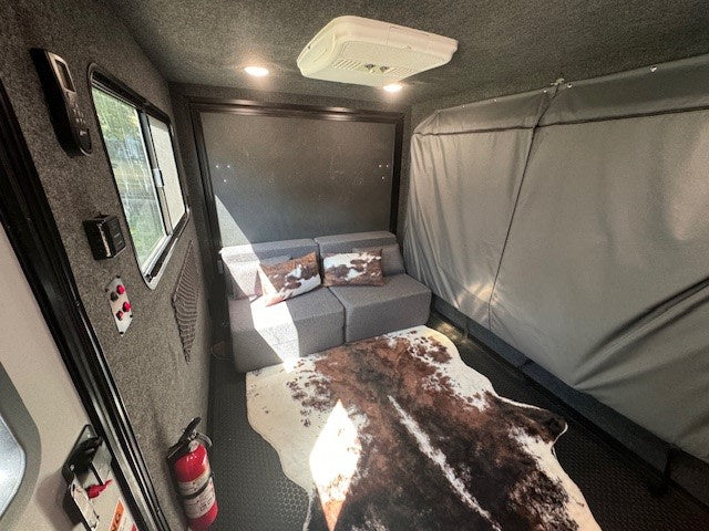 and stylish cowhide rug. Ready for adventure!|This RV rental showcases a compact interior with a "Flyer" cooler — photo 8