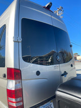 Rear view of a silver Mercedes-Benz Sprinter RV, branded Roadtrek, featuring a Van City RV sticker, possibly an rv rental.