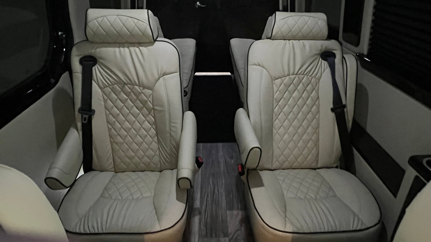 Experience premium comfort in our RV rental! Luxurious cream captain's chairs with diamond stitching and black piping.