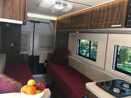 RV rental interior: cozy beds, efficient kitchen, ambient lighting. Explore the open road in comfort.