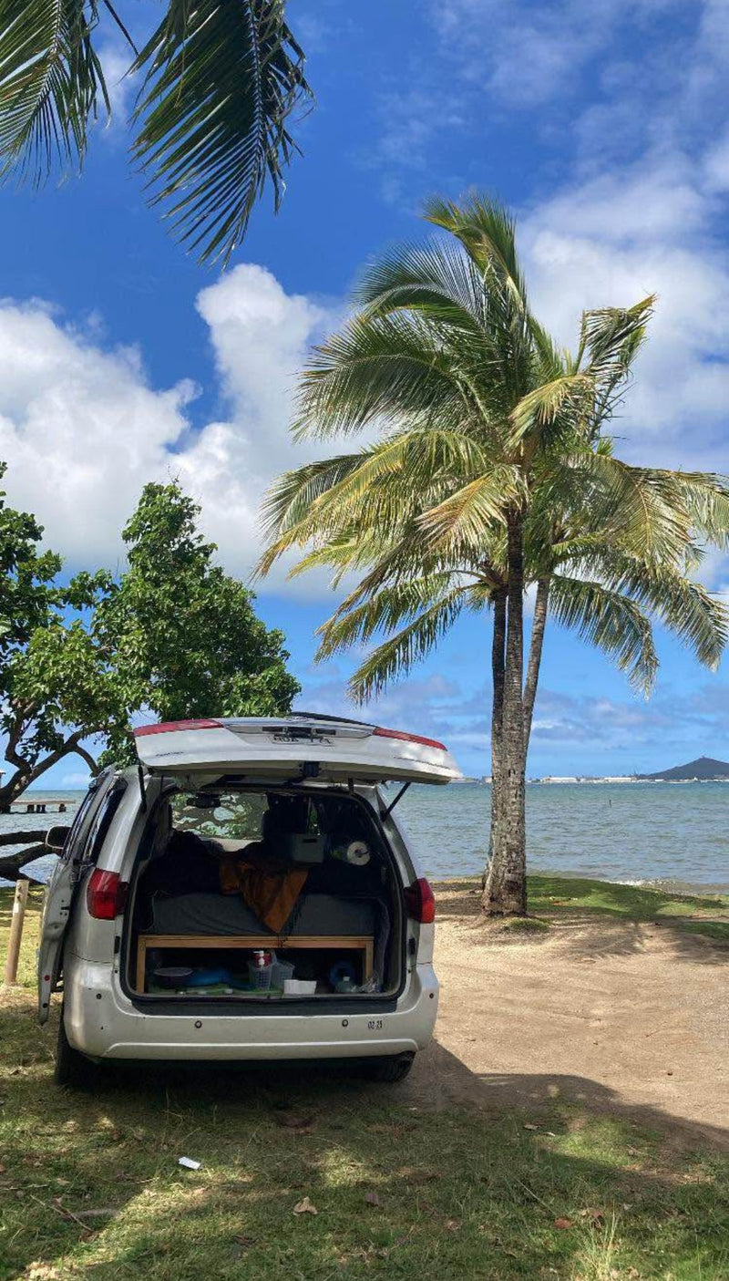  and outside park.|This converted SUV offers a cozy bed & storage for car camping/van life — photo 12