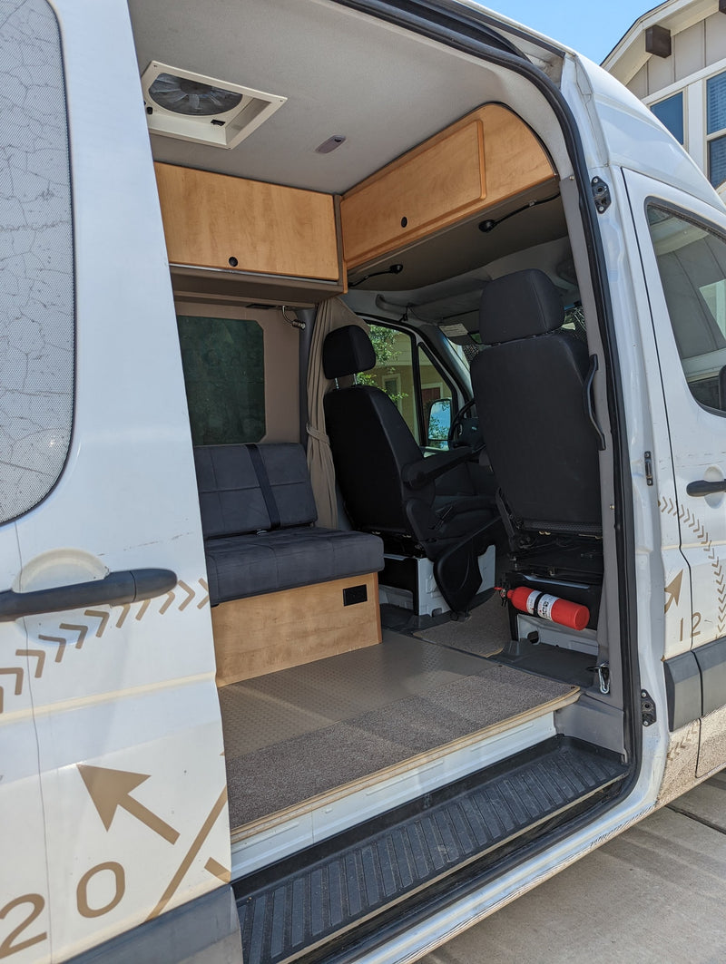 Step inside this rv rental! Features custom wood cabinetry, bench seating, and a fire extinguisher for your adventure. — photo 1