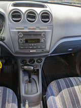 RV rental interior showing the dashboard, Ford SYNC infotainment system, automatic gear shift, and patterned seats.