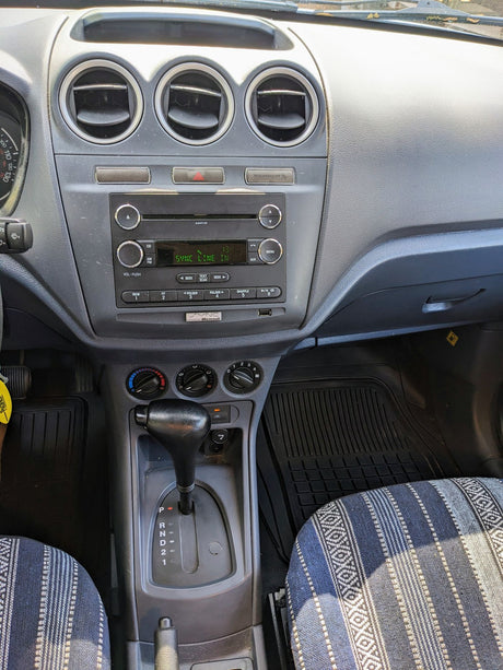 RV rental interior showing the dashboard, Ford SYNC infotainment system, automatic gear shift, and patterned seats.