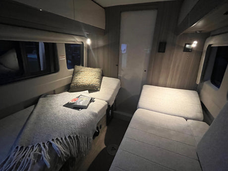Cozy RV rental interior featuring versatile seating areas, convertible to beds, ideal for travel.