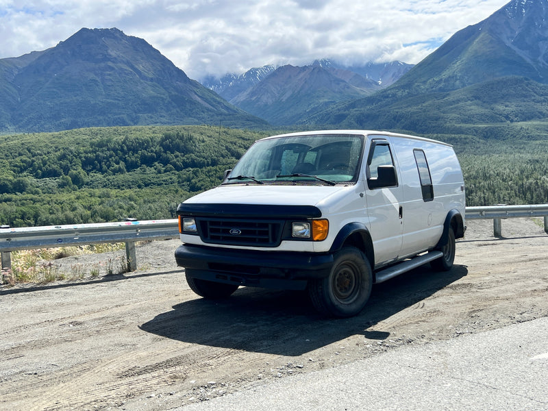 White Ford van in a mountain landscape — photo 1