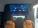 Luxury RV rental interior with Mercedes-Benz seats & a large smart TV showing streaming apps for onboard entertainment.