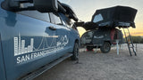 San Francisco Overland's truck & **RV rental** trailer with deployed rooftop tent and open kitchen, ready for outdoor overlanding.