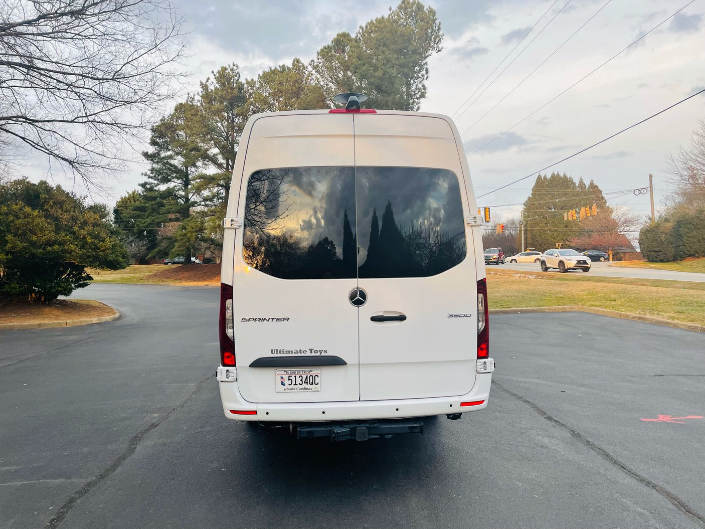 White Mercedes-Benz Sprinter van, likely an rv rental, parked from rear view. Features 'Ultimate Toys' badging & SC plate.