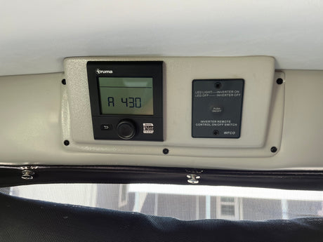 RV rental interior: Truma climate control panel displaying "A 430" and a WFCO inverter remote switch for power.