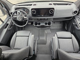 Modern rv rental van cockpit: dashboard, Mercedes steering wheel, infotainment, dual seats, and cup holders visible.