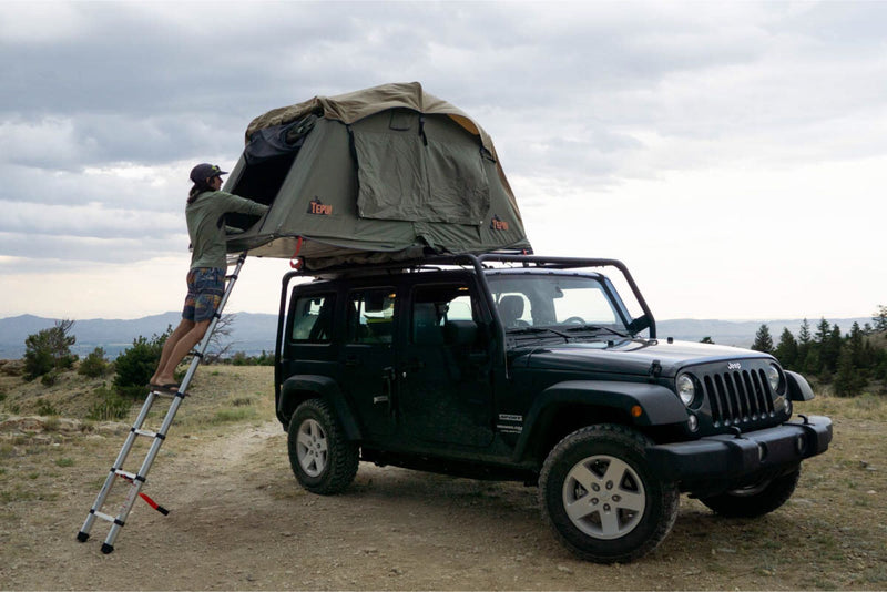  ready for RV rental adventures.|This rugged black Jeep with an open roof-top tent and ladder is perfect for your next RV rental camping trip.|Rugged Jeep with rooftop tent — photo 6