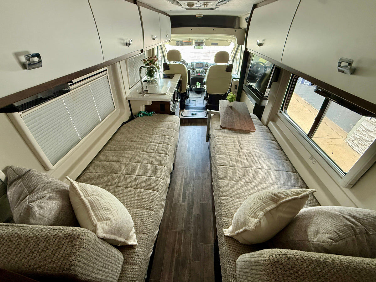 Spacious RV rental interior with twin beds, kitchen, and cockpit. Ideal for comfortable road trip adventures. — photo 4