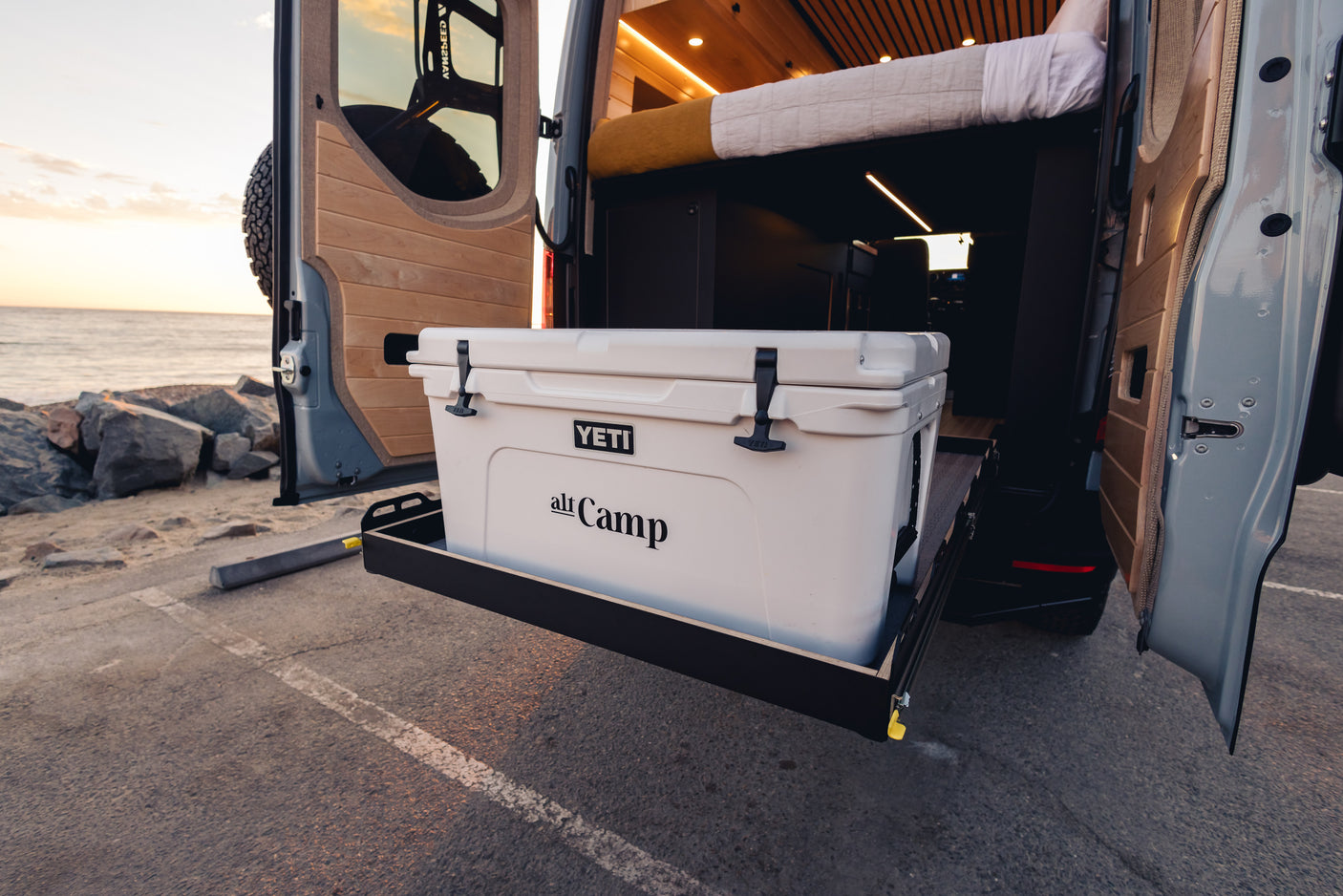 Adventure-ready RV rental van with a pull-out YETI cooler, perfect for beach camping. Enjoy van life by the sea!