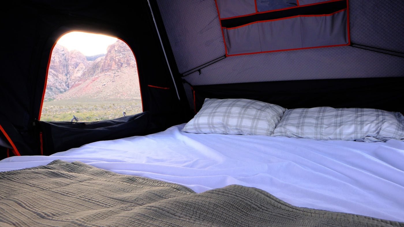 Enjoy comfortable camping in this RV rental's rooftop tent, offering a snug bed, pillows, and stunning mountain views. — photo 19