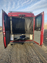 This RV rental camper van showcases its organized rear storage and privacy screen. Ideal for outdoor adventures and mobile living.