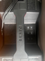 ION speaker control panel in an RV rental, showing power, volume, and playback buttons, plus a charging cable.