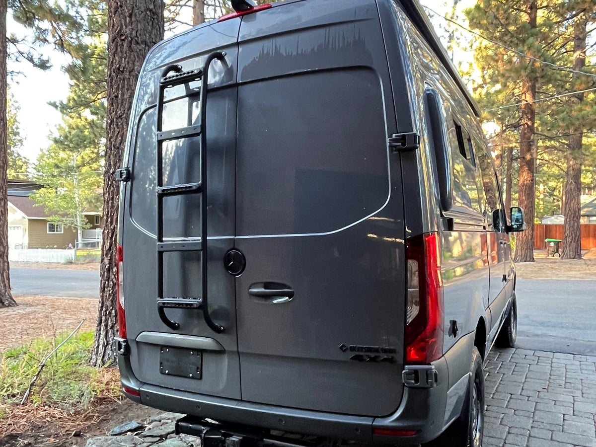  and storage cabinets.|Rear of a gray Mercedes Sprinter 4x4 camper van — photo 6