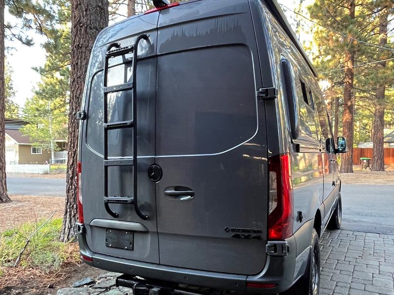  and storage cabinets.|Rear of a gray Mercedes Sprinter 4x4 camper van — photo 6