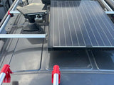 RV rental roof: Black Starlink satellite dish and large solar panel, ideal for off-grid power and internet.